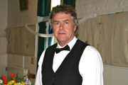 Man dressed in white collared shirt and bowtie