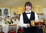 Young waiter serving drinks
